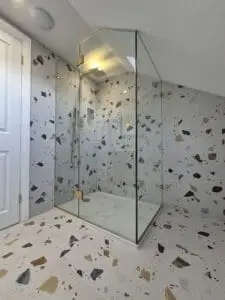 Minimalist glass shower enclosure for sloping ceiling bathroom in London