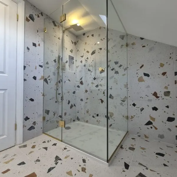 Minimalist glass shower enclosure for sloping ceiling bathroom in London
