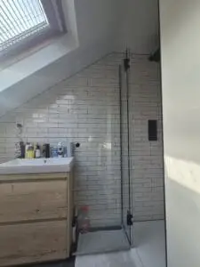 Made-to-measure glass shower enclosure for an angled ceiling bathroom