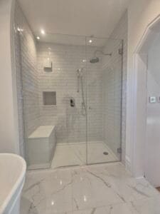 Custom glass shower enclosure with hinged door in South West London