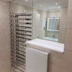 Modern mirror wall feature installed in a London apartment