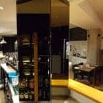 Bronze tinted mirror wall installation on pillar