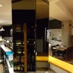 Bronze tinted mirror wall installation on pillar