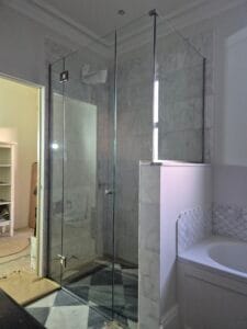 Bespoke glass shower enclosure with brushed nickel fittings in South West London