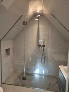 Custom made glass shower enclosure for loft bathroom with sloped ceiling London