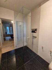 Custom glass shower screen installation in modern London bathroom