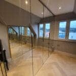 Full height mirror wall installation in a living room in South West London