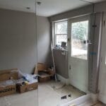 Seamless full height mirror wall installation in a residential corridor