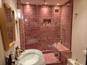 Custom glass shower door with antique brass fittings in luxury London bathroom