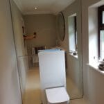 Modern mirror wall feature installed in a London apartment toilet