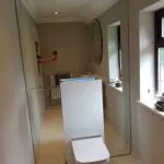 Modern mirror wall feature installed in a London apartment toilet