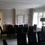 Full height mirror wall reflecting natural light in a contemporary living room